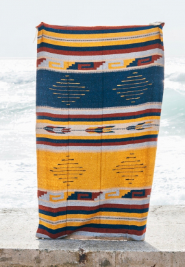 Mexican blanket or beach rug in yellow and blue tones and tribal patterns