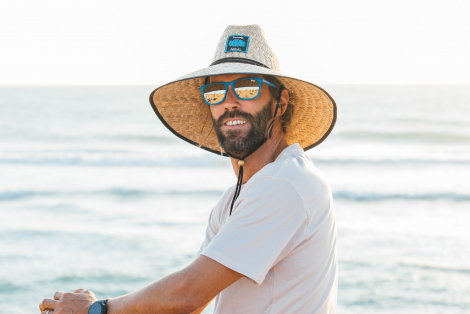 Man in Californian lifeguard hat looking at the camera