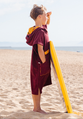 boy with burgundy surf poncho