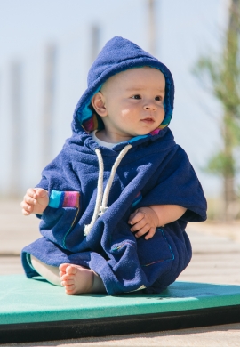 baby with blue towel poncho